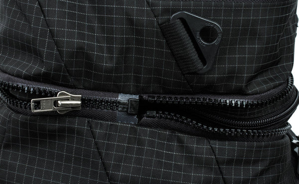 The zipper that connects the top pocket to the main bag.